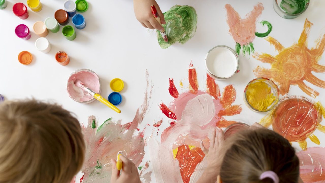 close-up-kids-painting-with-brushes-together