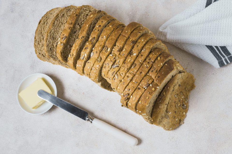 top-view-slices-bread-with-butter-knife