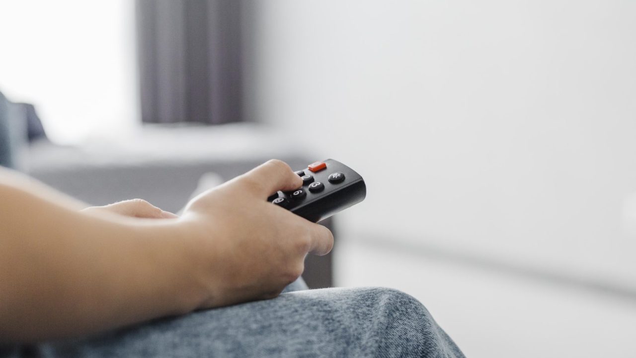 close-up-person-using-television-remote