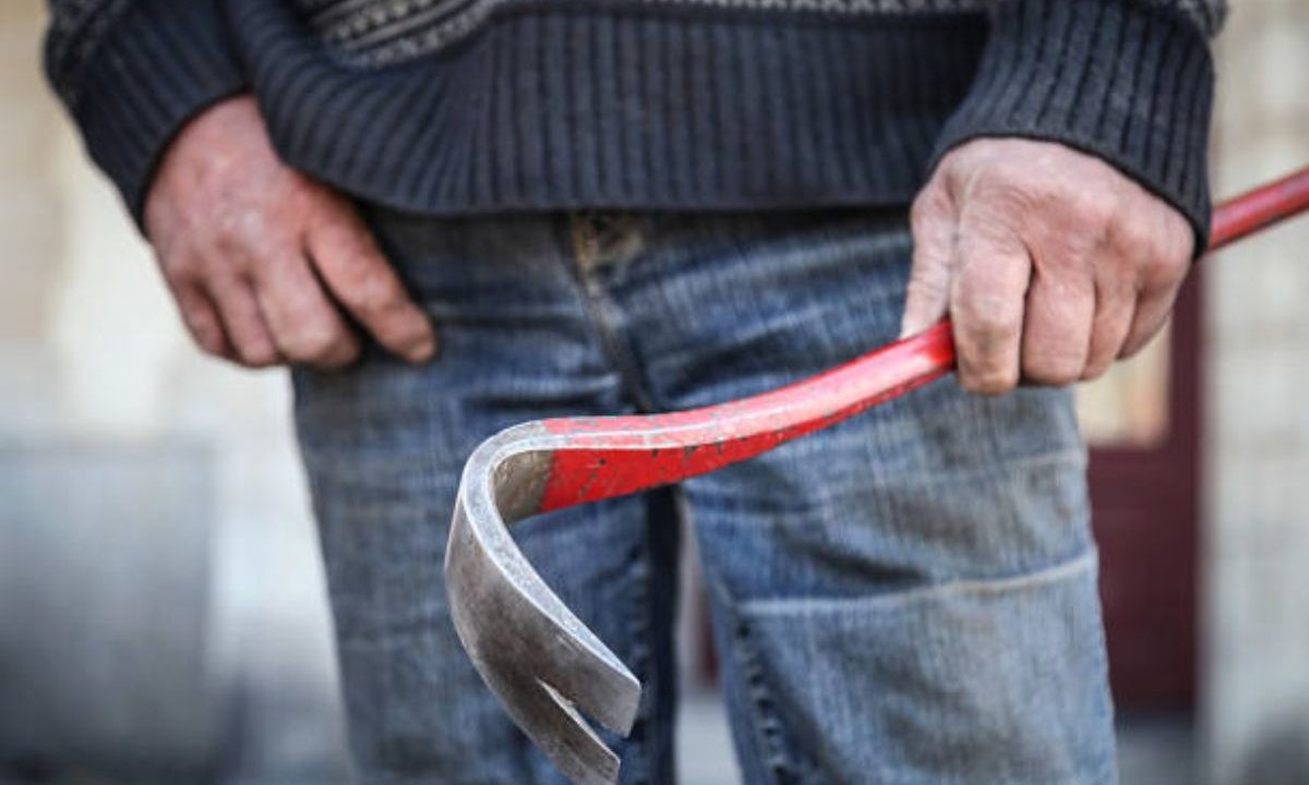 homem segurando barra de ferro