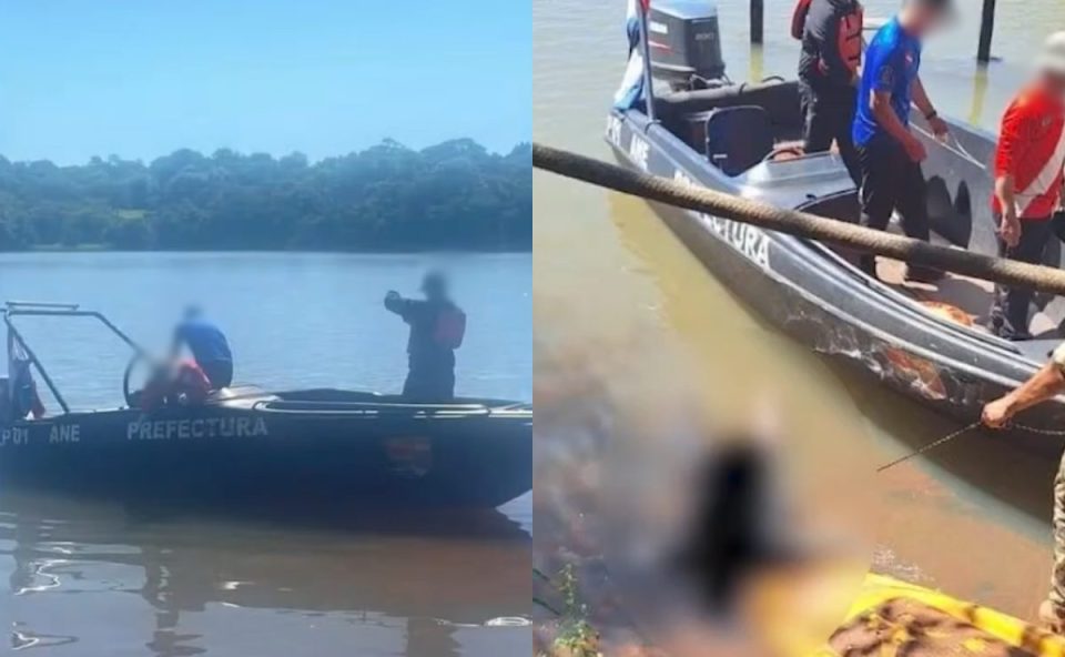 Corpo encontrado em lago no Paraguai é apontado como de quarto suspeito de falsa operação do Gaeco. Imagem mostra momento em que encontram o corpo. Aparece um barco e pessoas perto do corpo boiando.