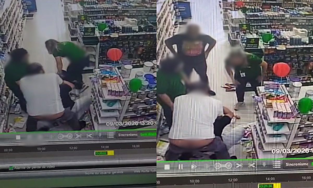 Médico é agredido por funcionário de farmácia em Curitiba. Imagem mostra o momento da agressão. Funcionários com camiseta verde estão perto da situção. Um homem de branco segura a vítima. Rafael está com camiseta preta. Há várias prateleiras na cena.