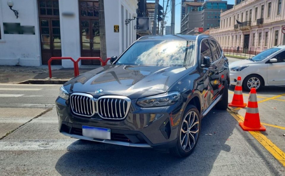 BMW com a lateral amassada depois de acidente com um ônibus biarticulado em um cruzamento no bairro Rebouças, em Curitiba.