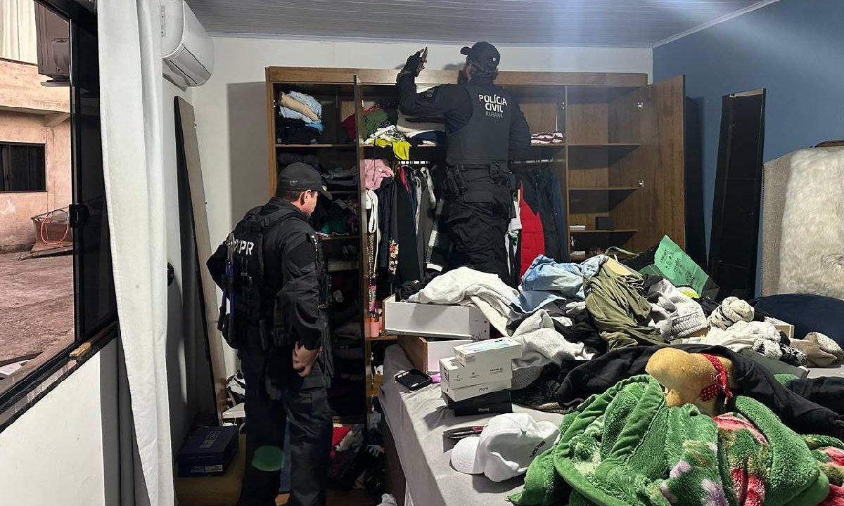 Foto mostra policiais fazendo busca em guarda-roupas