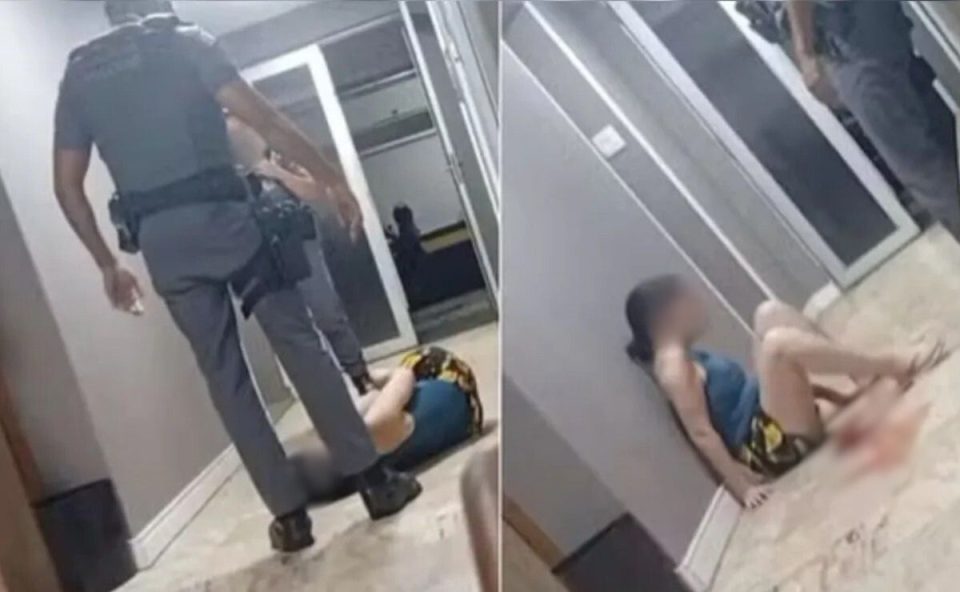 Policiais militares cercam uma mulher caída no chão em um condomínio no litoral de São Paulo, após um policial militar ser flagrado agredindo a vítima.