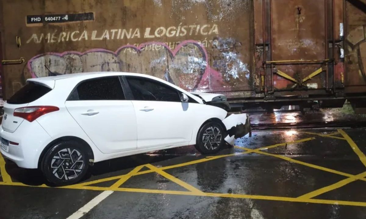 Carro com a frente amassada após bater no trem