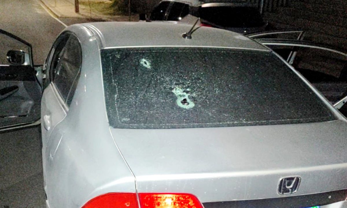 Carro com o vidro traseiro destruído, após disparos realizados por amigos próximos a um homem morto a tiros em Almirante Tamandaré.
