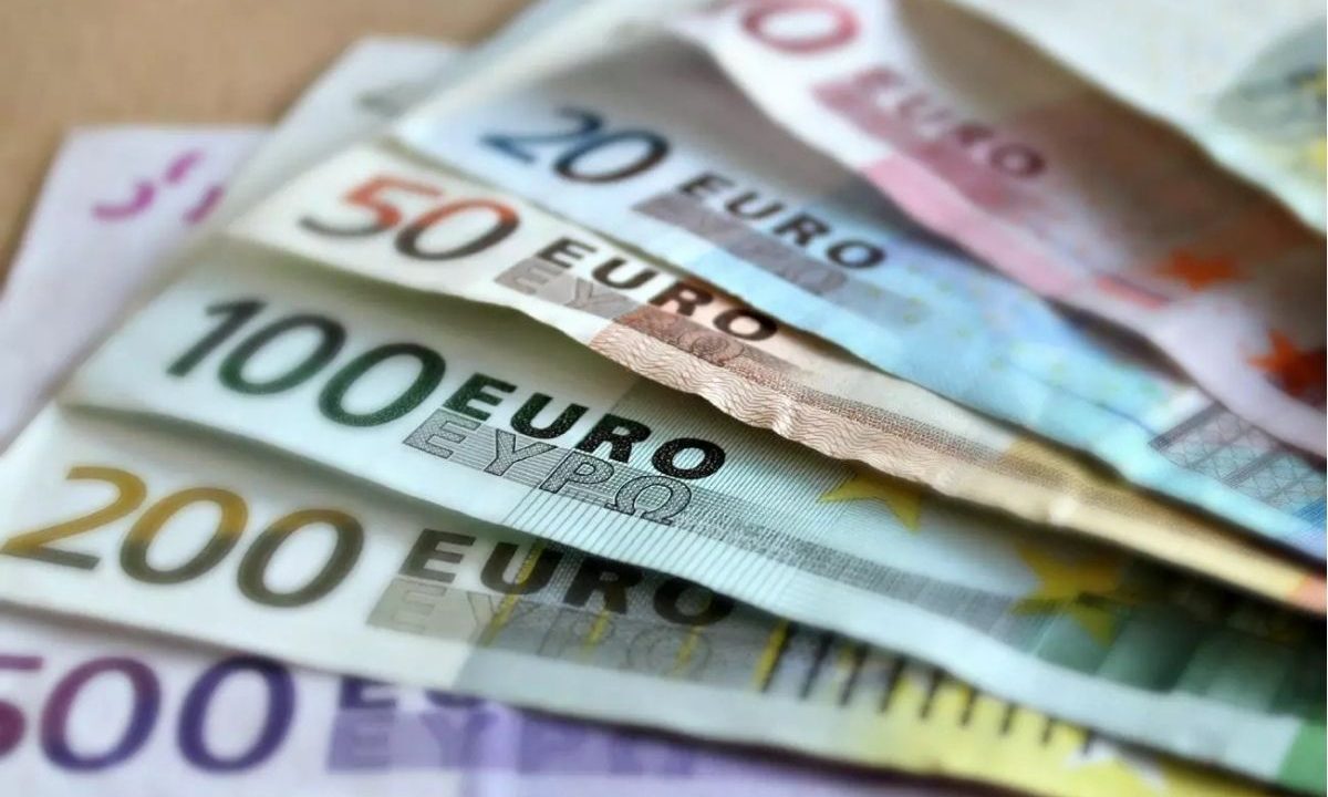Cédulas de Euro empilhadas em leque sobre uma superfície, ilustrando a discussão econômica sobre a jornada de trabalho na Alemanha.