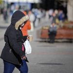 Foto mostra mulher com frio após declínio de temperatura no Paraná