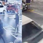 Imagem de câmera de segurança mostra dois homens caminhando pelo estacionamento de um supermercado em Curitiba antes do roubo investigado pela Polícia Civil.